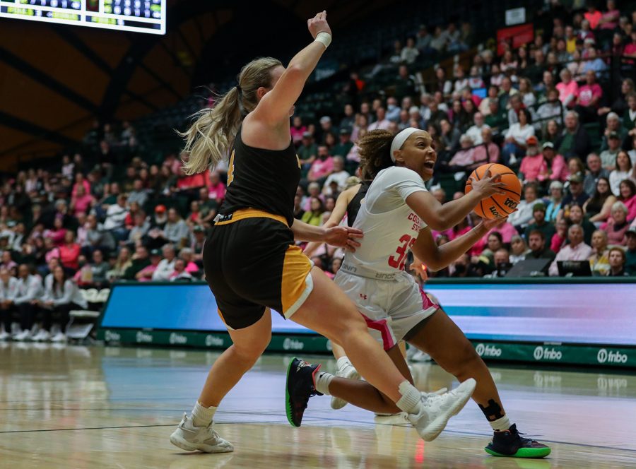 Colorado+State+University+guard+Cailyn+Crocker+%2832%29+pushes+through+the+University+of+Wyoming+defense+to+make+a+layup+at+Moby+Arena+Feb.+4%2C+2023.+The+Rams+won+66-63+in+the+first+Border+War+matchup+of+the+season.