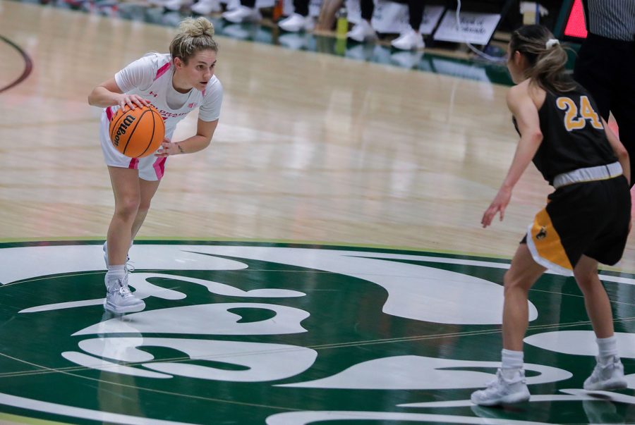 Colorado State University guard McKenna Hofschild (4) slowly approaches University of Wyoming guard Tommi Olson (24) at Moby Arena Feb. 4, 2023. The Rams won 66-63.