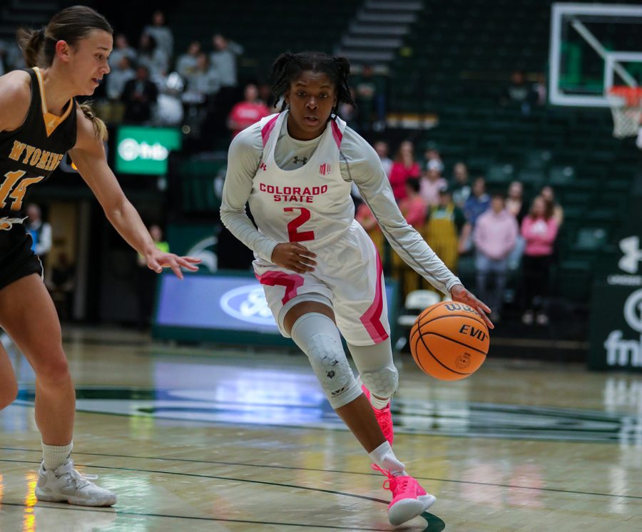 Colorado State University guard Destiny Thurman (2) drives to the basket around University of Wyoming guard Quinn Weidemann (14) at Moby Arena Feb. 4, 2023. The Rams won 66-63.
