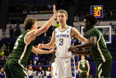 Colorado State University guards Baylor Hebb (5) and Isaiah Stevens (4) defend United States Air Force Academy guard Jake Heidbreder (3) Feb. 7. The Rams won 69-53.