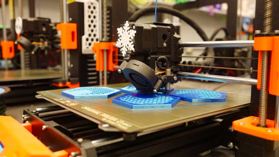 A 3D printer in the Idea 2 Product Lab prints out pieces for a board game Feb 10.