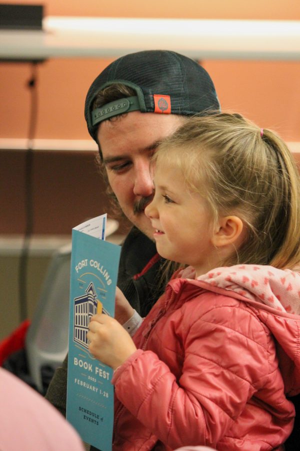 A child and her father laugh as they enjoy The Story Baker’s performance filled with entertainment at the Old Town Library Feb 3. Each performance features and brings to life local student composed stories.