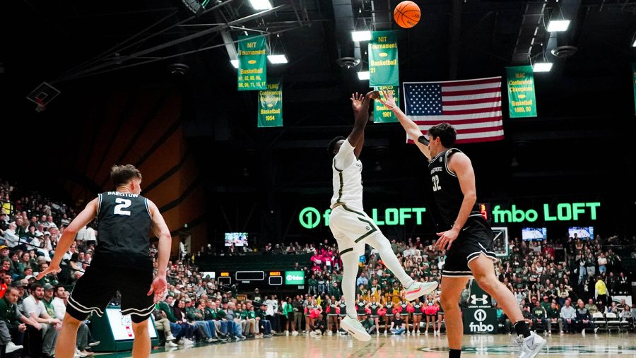 Colorado State University forward Isaiah Stevens (4) shoots the ball while being guarded by a Utah State University player