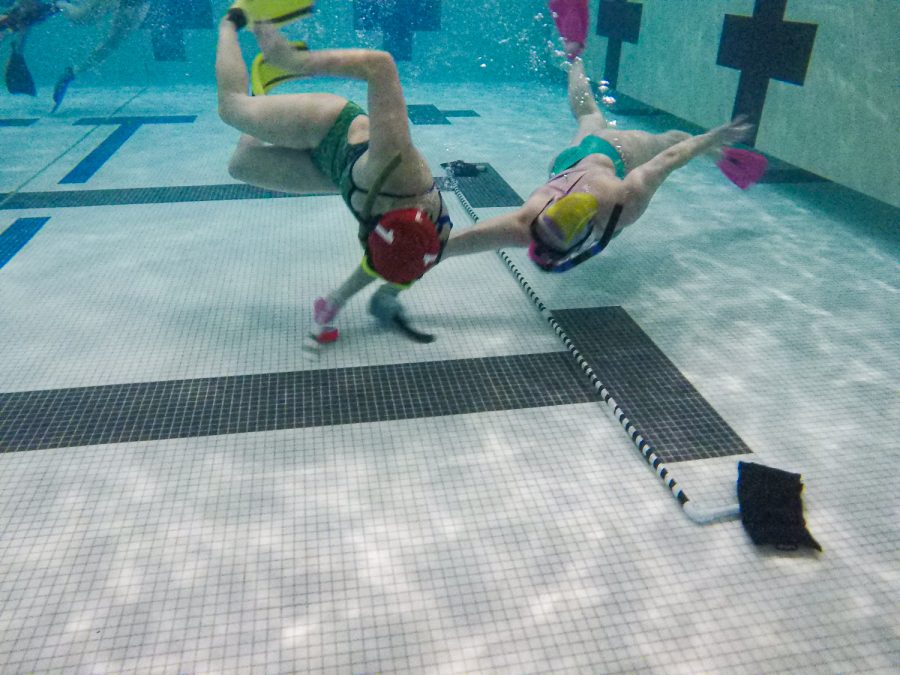 Underwater hockey players dual for the puck at Edora Pool Ice Center (EPIC) Feb. 7.
