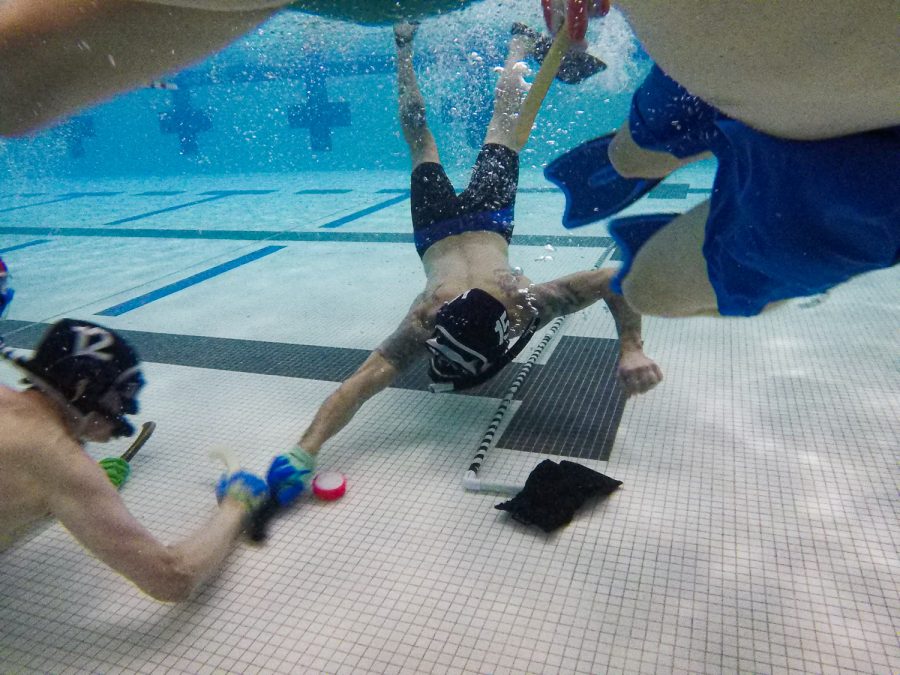 Underwater hockey players dual for the puck at Edora Pool Ice Center (EPIC) Feb. 7.