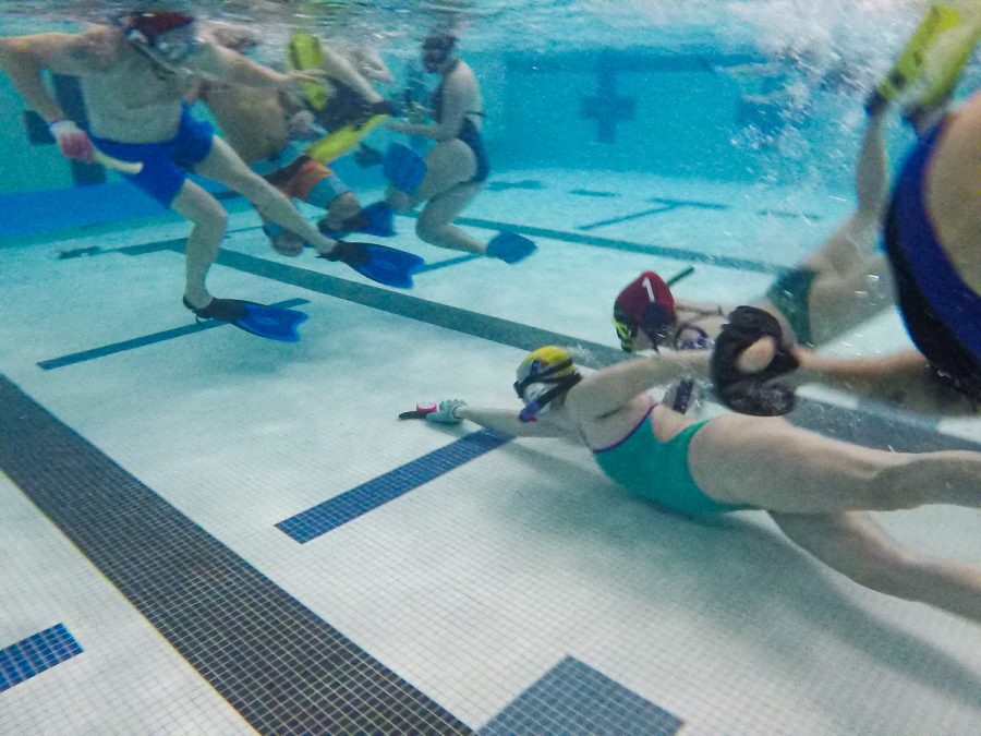Underwater hockey player reaches for the puck at Edora Pool Ice Center (EPIC) Feb. 7.
