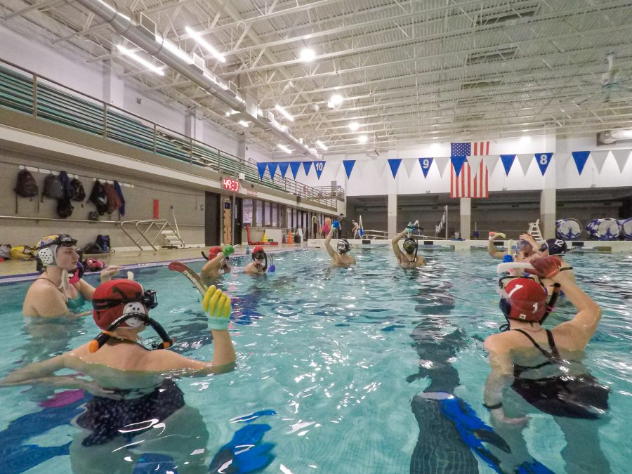 Underwater hockey players meet together to discuss about rules and decide teams before the scrimmage at Edora Pool Ice Center (EPIC) recreation center in Fort Collins, Colorado Feb. 7