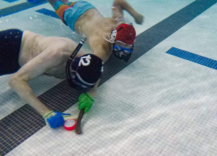 Underwater hockey players dual for the puck at Edora Pool Ice Center (EPIC) Feb. 7.