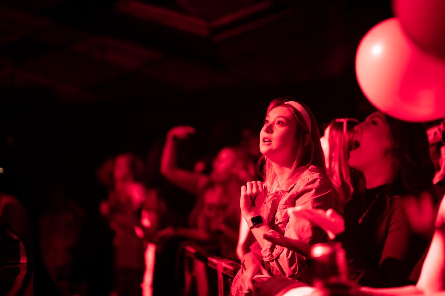 A Taylor Swift fan watches the Taylor Fest organizers dance along to Swift’s music onstage in front of a sold-out Aggie Theatre crowd Feb. 11.