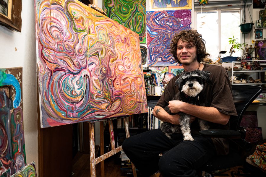 Trevor Stewart works on a painting titled “Alchemical So(u)n” in his Fort Collins home