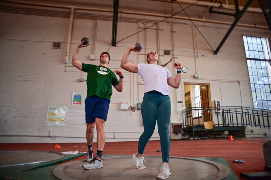 Jackson Morris and Gabi McDonald, Colorado State University track and field athletes, practice with the outdoor shot put at the Glen Morris Fieldhouse Feb. 14.