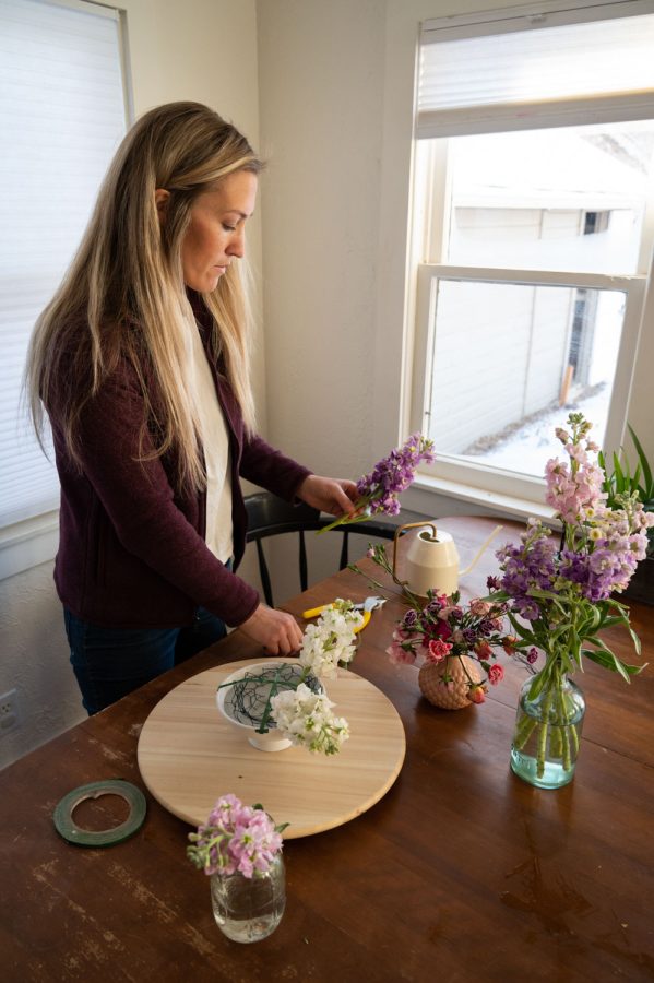 Kelsey Brons, owner of Ardent Rose Floral Design in Loveland, Colorado, creates a small arrangement, made up of leftover flowers she had, in her home Feb 16th. Brons knew that she wanted to work with flowers since she was young, as she grew up near the foothills in Northern Colorado, picking wildflowers with her mother and neighbors. “My motto is, ‘Be passionate and be faithful,’” Brons says, “All else will follow if these two things are my goal.” 