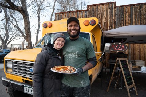 Project Pizza co-owners Colleen Constant and Isaiah Ruffin pose with a pizza outside of their food truck parked at Stodgy Brewing Company in Fort Collins Feb. 20.
