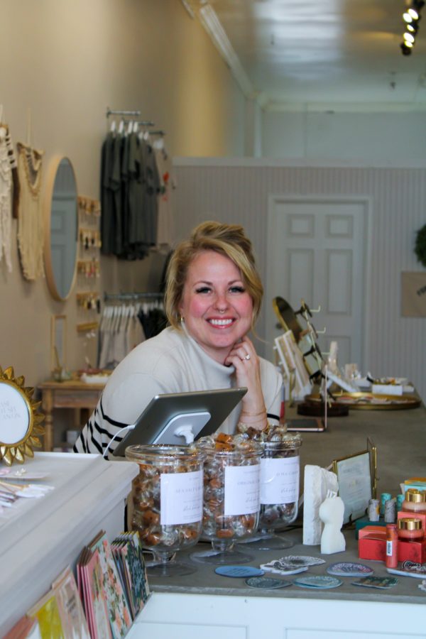Emilie Casseday, the owner of Blush Boutique, smiles behind the counter of her new store Mar. 5. My mission is to really love the people who walk through the door, Casseday said.  When I started Blush that wasnt really what I was going for but throughout the process Ive realized that I want people to feel seen when they walk in the door.