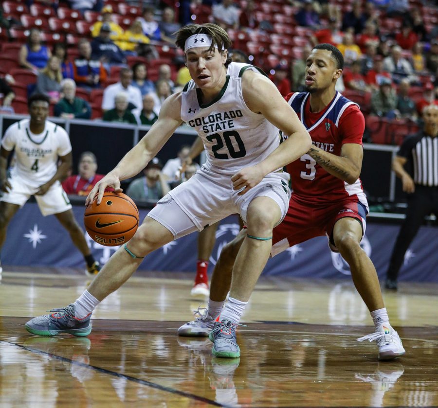 Colorado State University guard Joe Plamer (20) pushes around California State University, Fresno guard Isaiah Hill (3) in the Thomas & Mack Center in Las Vegas March 8, 2023. The Rams won 67-65 in the first round of the 2023 Mountain West Basketball Championships.