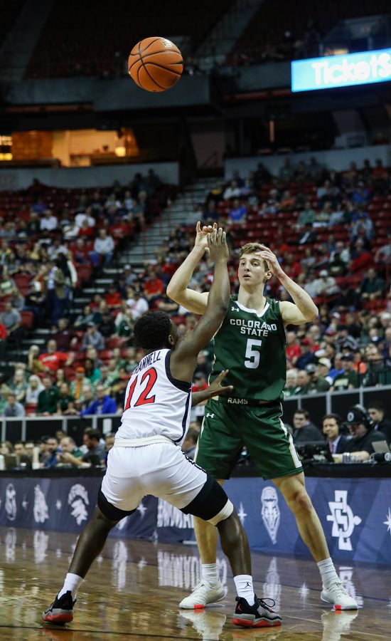 Colorado State University guard Baylor Hebb (5) makes a pass over San Diego State University guard Darrion Trammell (12) in the Thomas & Mack Center in Las Vegas March 9, 2023. The Rams lost 64-61 in the quarterfinals of the 2023 Mountain West Basketball Championships.