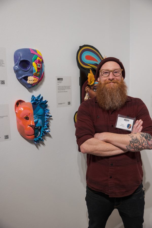 Dave Colangelo with his artwork, Mask Anatomy 101, during the opening night of the Masks Exhibition at the Museum of Art Fort Collins March 3. Im an occupational therapist, so in school I studied anatomy and physiology and had to learn all the ins and outs of the human body, Colangelo said. I dont use any of that now, really, but I was always inspired by the art that these doctors and these artists put into these textbooks, so I did kind of a humorous take on what a face would look like. Fake muscles - with a little bit of real muscles - and silly colors. Colangelo has been a contributor to the exhibit for six years and spent two months on this years mask.