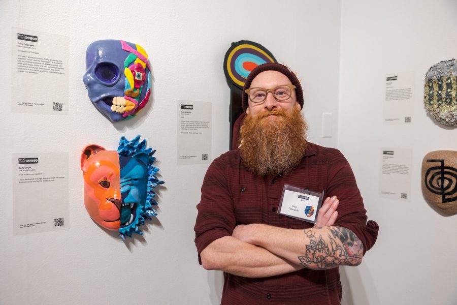 Dave Colangelo with his artwork, Mask Anatomy 101, during the opening night of the Masks Exhibition at the Museum of Art Fort Collins March 3. Im an occupational therapist, so in school I studied anatomy and physiology and had to learn all the ins and outs of the human body, Colangelo said. I dont use any of that now, really, but I was always inspired by the art that these doctors and these artists put into these textbooks, so I did kind of a humorous take on what a face would look like. Fake muscles - with a little bit of real muscles - and silly colors. Colangelo has been a contributor to the exhibit for six years and spent two months on this years mask.
