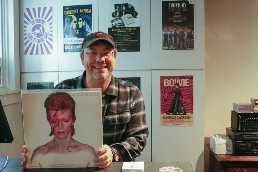 Jason Gorbett, owner of Songbyrd Records, smiles while holding David Bowie’s Aladdin Sane, one of his favorite artists’ albums March 18. “When I was a teenager, I had some pretty rough times and music really saved my life,” Gorbett said. “Local record stores were places that I could go that were safe, where I could learn about things, where I could meet other weirdos like me, and discover the world.” Gorbett sees great importance in continuing to keep vinyls and record stores alive in our current society because, “they transcend time and space and culture… they are the universal ambassadors of joy.”