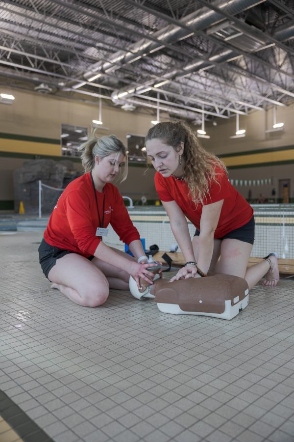 Colorado State University lifeguards Annie Scott and Paige Foster practice CPR during lifeguard audits at the Campus Recreation Center March 20.