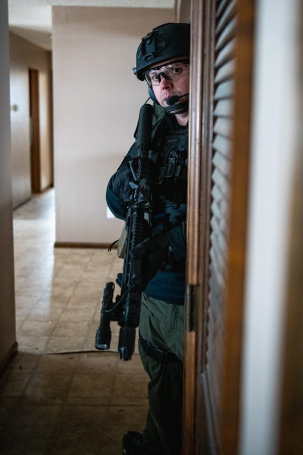 Officer Aaron Westby peeks around a corner during a Fort Collins Police Services SWAT team practice Feb. 15.