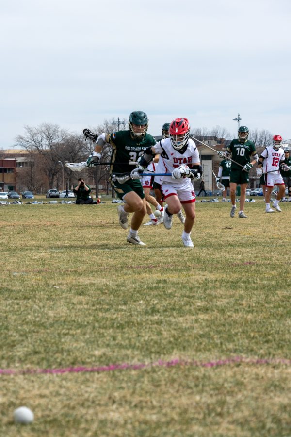 Colorado States Kevin Mulligan (32) and Utah States Nick Kreipl (32) race after the ball April 8.