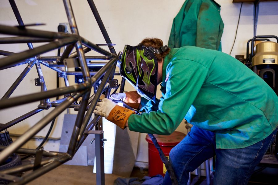 Liam Kjosen, senior mechanical engineering student, welds tabs for components to mount onto the frame of the Ram Racing vehicle March 4. These tabs connect various parts to the frame of the vehicle.
