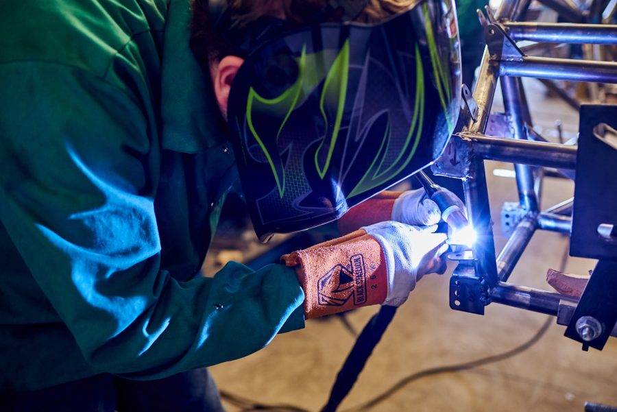 Liam Kjosen, senior mechanical engineering student, welds tabs for components to mount onto the frame of the Ram Racing vehicle March 4. These tabs connect various parts to the frame of the vehicle.
