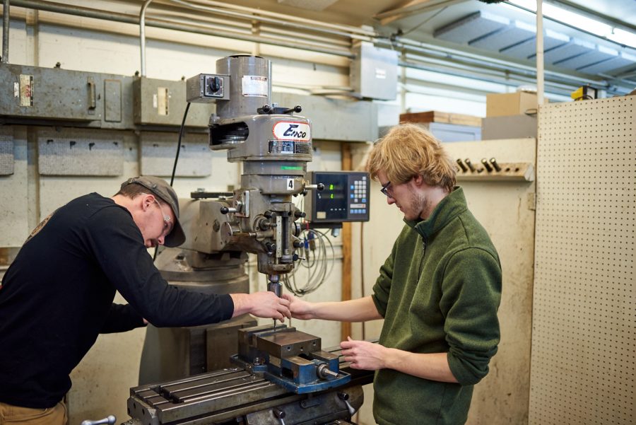 Connor Shelton and Gus Trimble, senior mechanical engineering students, replace a drill bit in a milling machine at the Engineering Research Center Jan. 28. Drill bits are replaced when they get dull to allow for clean cuts.
