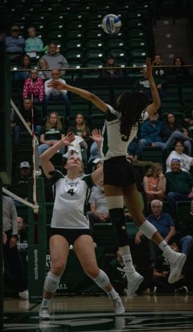 Emery Herman (4) sets the ball to Naeemah Weathers (9) to get a kill during their scrimmage against University of Colorado Boulder at Moby Arena April. 8. The game ended with a tie 6-6.