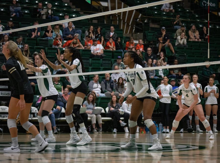 Kennedy Stanford, Naeemah Weathers and Alyssa Groves anticipate the ball coming back over the net from CU Boulder.