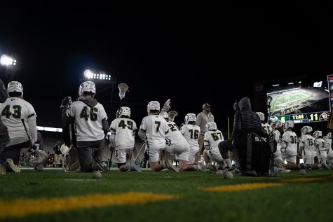 The Colorado State University mens lacrosse team take a knee during an injury in the game against University of Colorado Boulder April 15.