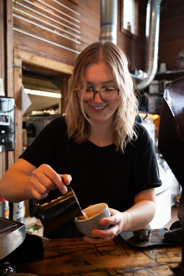 Savannah Wood, a barista a Bindle Coffee for three years now, pours latte art in a cappuccino at their Jessup Farms location in Fort Collins, CO, Apr 18. When asked what is special about her job Wood described how the job is creative at its core. “It’s a way to have a creative outlet”, Wood , “It’s a craft, you have to be really intentional with it. It takes intention and its fun of course! It is essentially a hobby that you get paid for.”