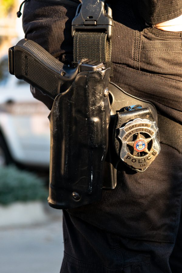A Fort Collins Police Services officers handgun and badge Oct. 5, 2022. The Fort Collins Police Services is comprised of 232 sworn personnel and responds to an average of 85,787 calls a year.