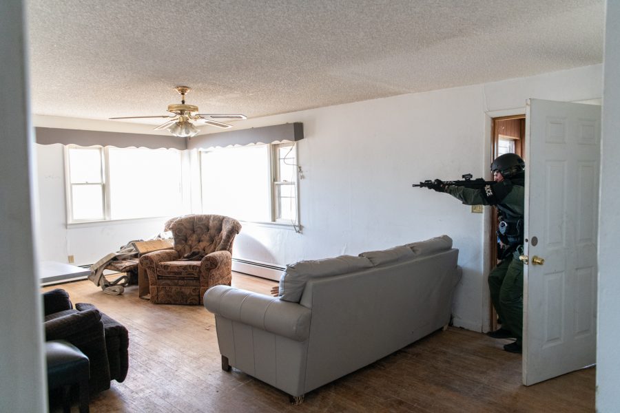 A member of the Fort Collins Police Services Special Weapons and Tactics team enters a house during a hostage rescue training Oct. 19, 2022.