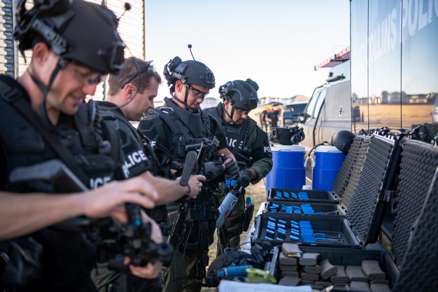 Members of the Fort Collins Police Services Special Weapons and Tactics team prepare for practice Oct. 19, 2022. For practice, the team loads their rifles with Simunition bullets, which leave a paint mark behind when fired.
