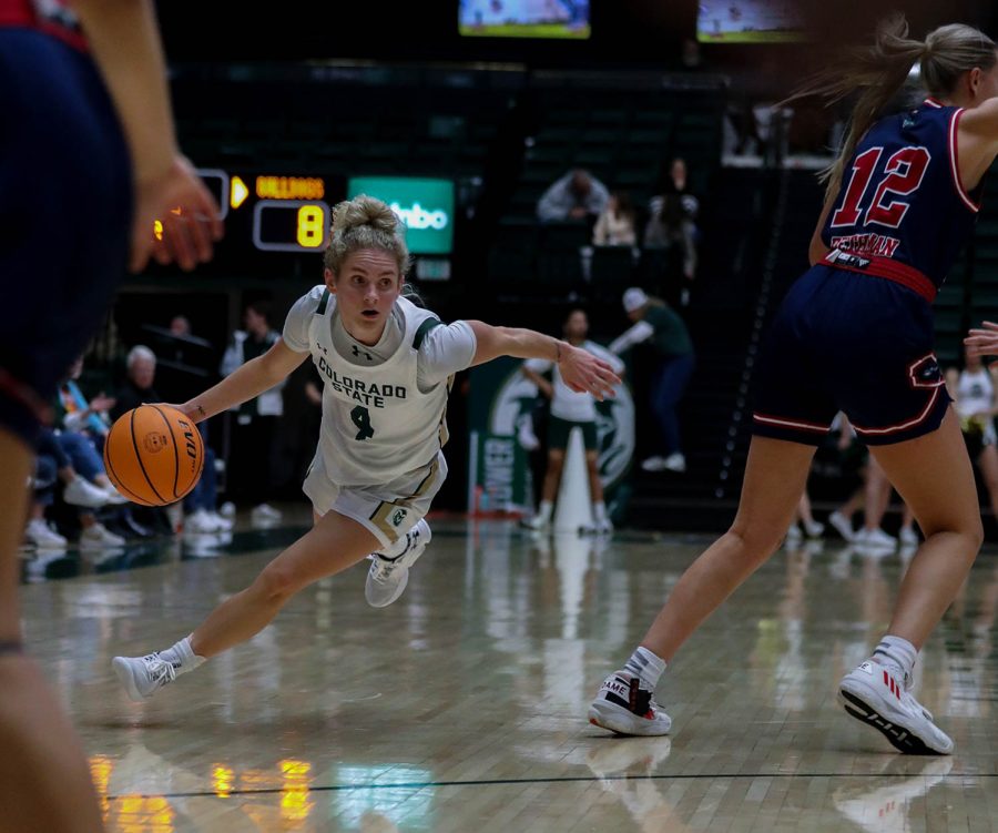 Colorado State University guard McKenna Hofschild (4) maneuvers around California State University, Fresno defenders at Moby Arena Dec. 29, 2022. The Rams won 64-58, with Hofschild contributing 29 points and 8 assists.