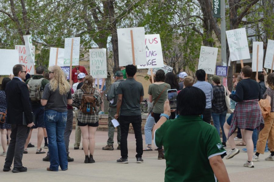 A Colorado State University employee stops on The Plaza to record a video of the Graduate Workers Organizing Cooperative's May 4, 2023 protest.