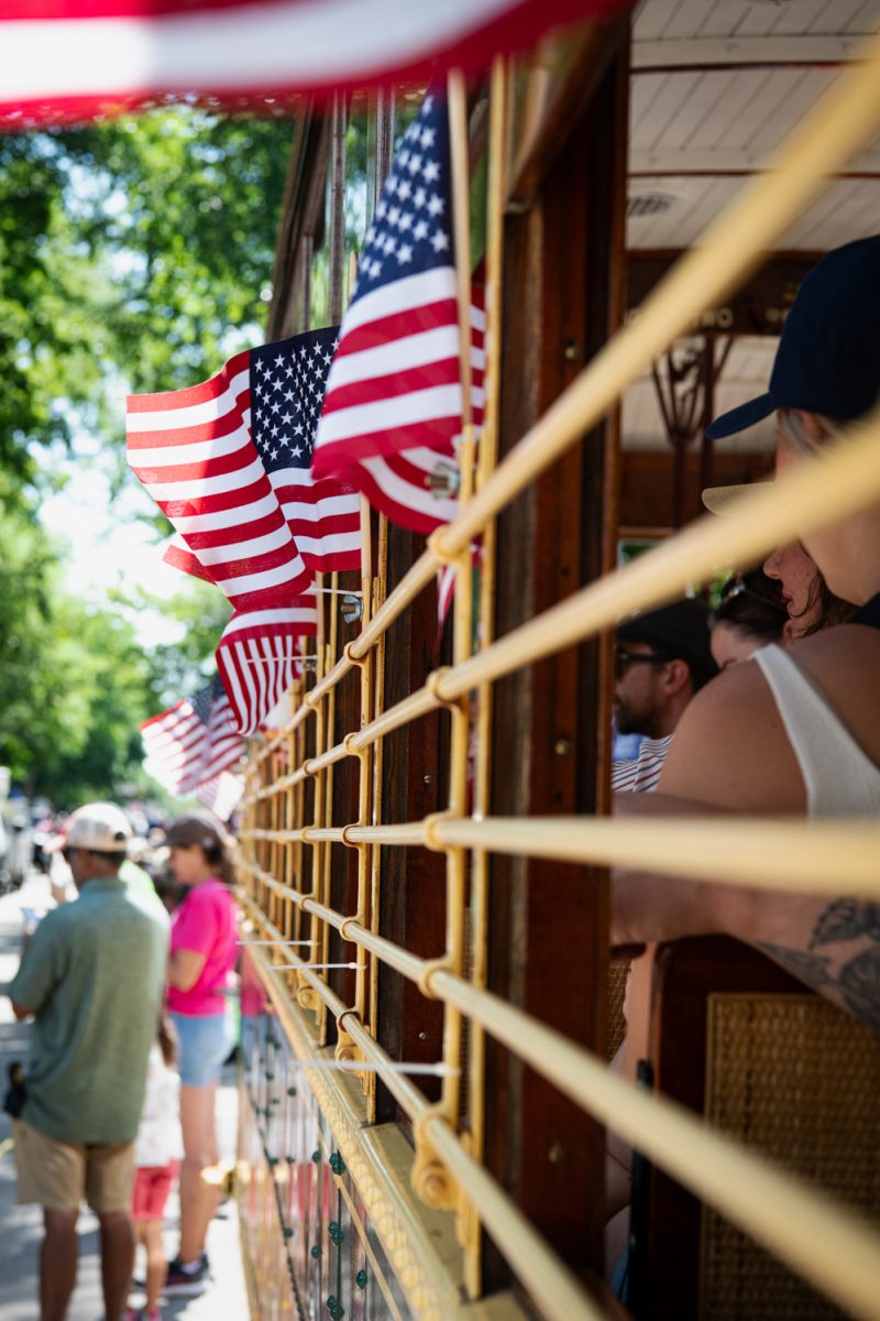 Spectators watch the annual Independence Day Parade in Fort Collins from the Trolly July 4.