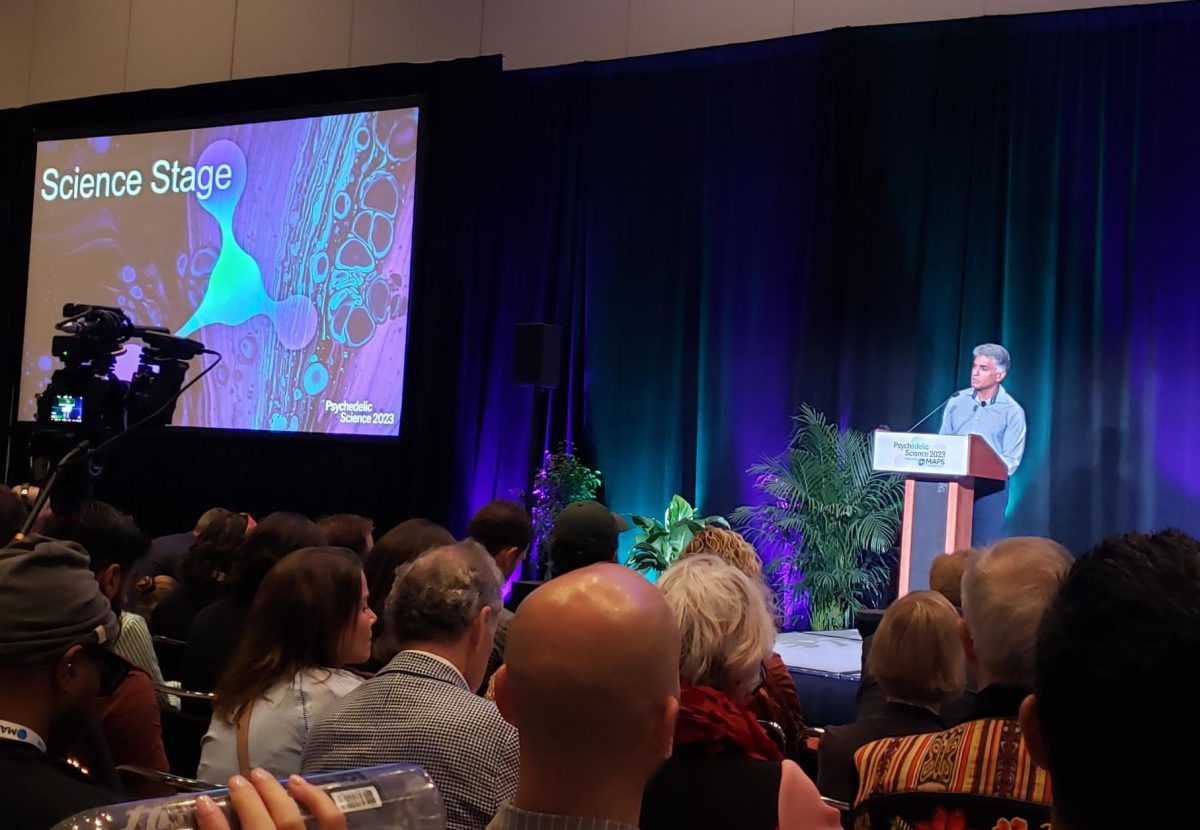 A speaker is introduced to the science stage at the Psychedelic Science 2023 conference in Denver, June 21.