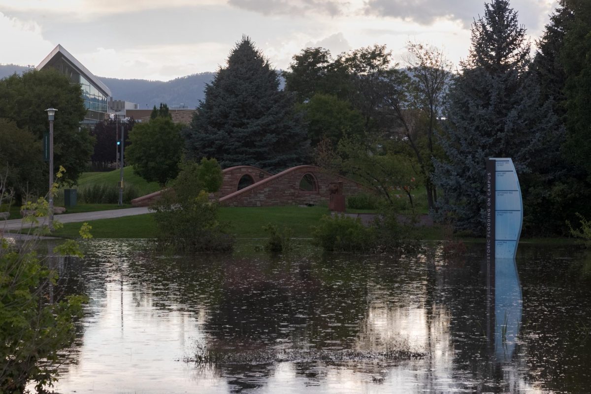 Flood water covering part of a flood depth marker at the Lory Student Center Lagoon at Colorado State University Aug. 1. The Lagoon was one of the only areas to remain flooded after the July 31 storm.