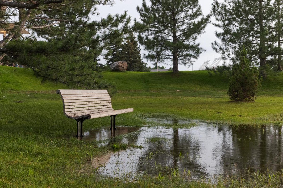 A bench on the edge of a flooded Lory Student Center Lagoon at Colorado State University Aug. 1. The Lagoon was one of the only areas to remain flooded after the July 31 storm.