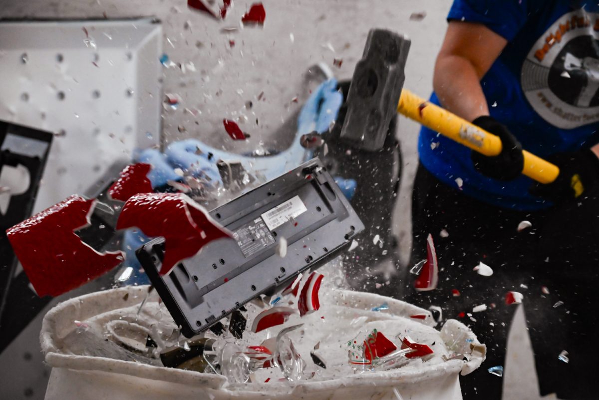 Corina Lee destroys a decorative red vase and a keyboard with a sledgehammer.