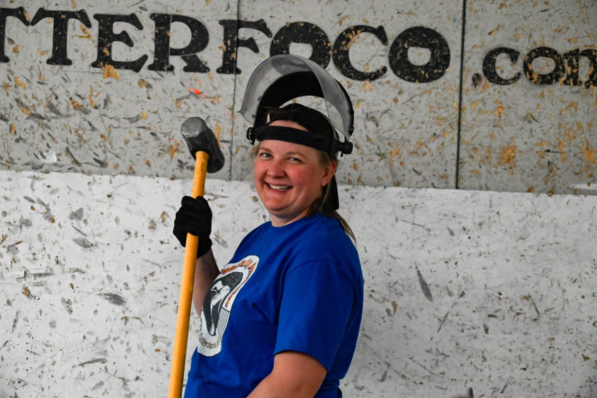 Corina Lee poses with a sledgehammer at Shatter Rage Room in Fort Collins.