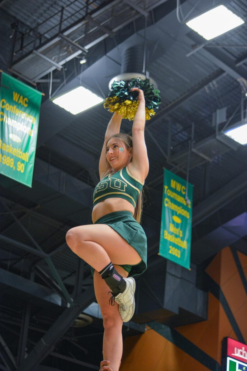 A Colorado State University cheerleader performs stunts at the CSU volleyball game vs. Bowling Green State University Sep. 7.

