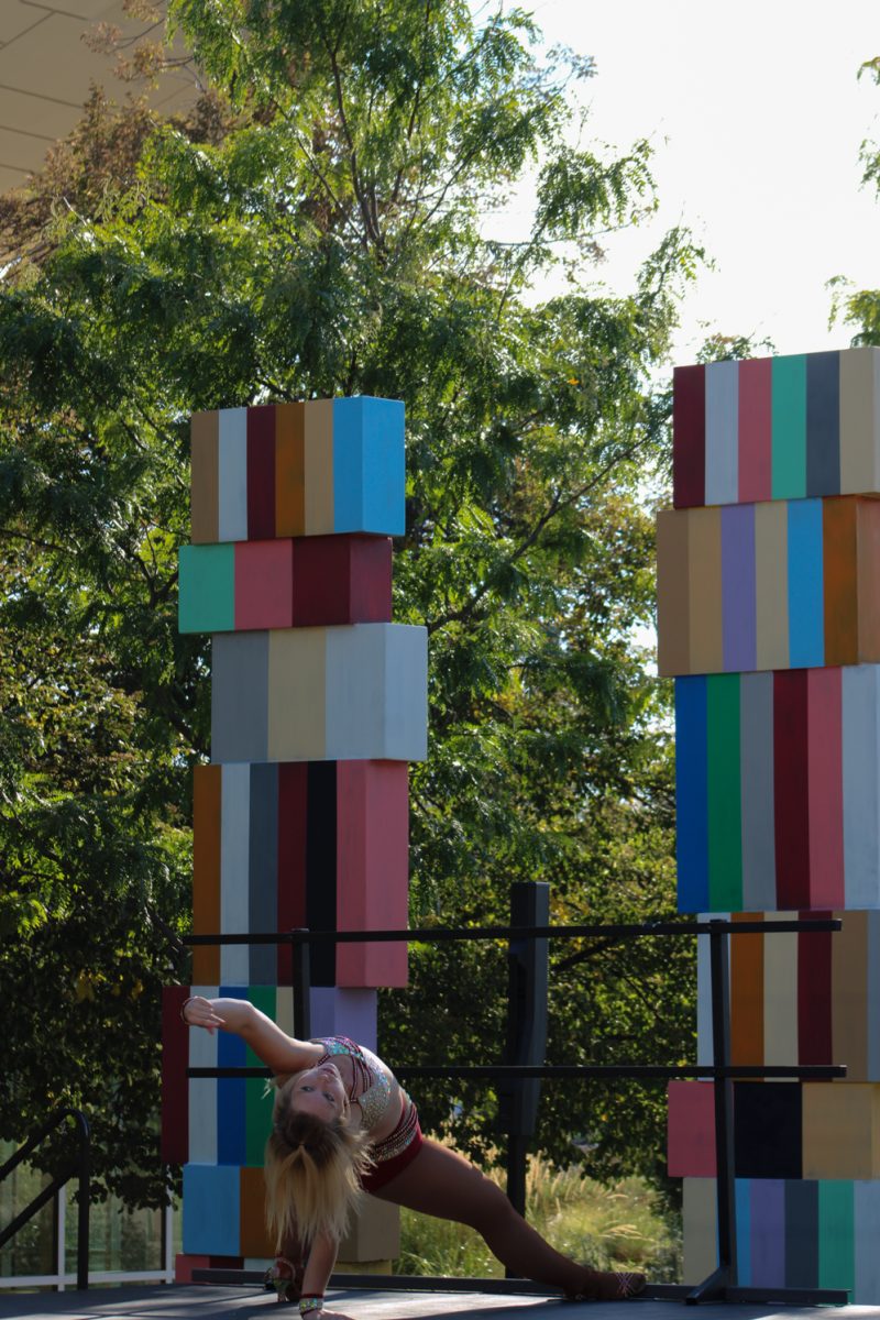 Fellow dancer from Bachata Denver shows off her flexibility by performing a back bend during her dance routine at the National Heritage Month launch at Colorado State University’s Sutherland Gardens Sept. 13. She showed off this dance routine as a precursor to the following dance activities that would occur, such as learning how to Bachata. 