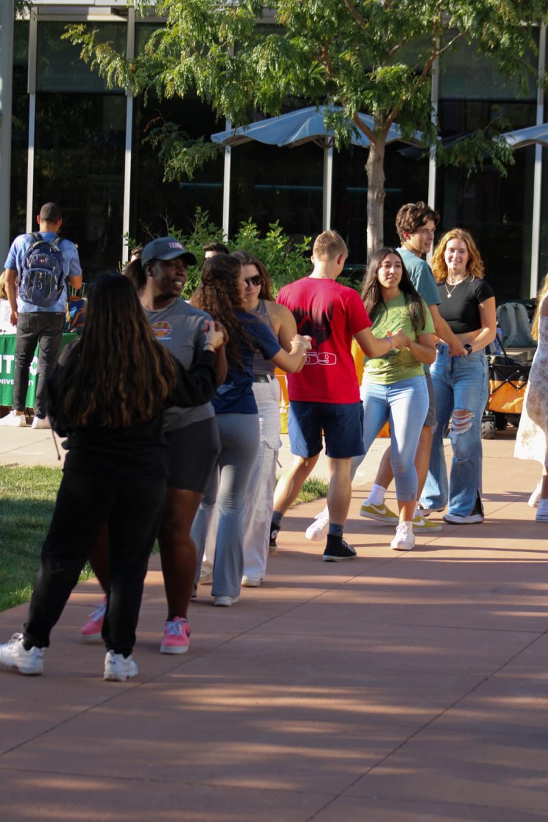 Colorado State University students dance in a line with their partners while learning Bachata at CSU’s Sutherland Garden for the National Latinx Heritage Month launch Sept. 13. El Centro hosted this event to allow students to connect with one another as well as learn about the Latinx culture in a fun and supportive environment. 