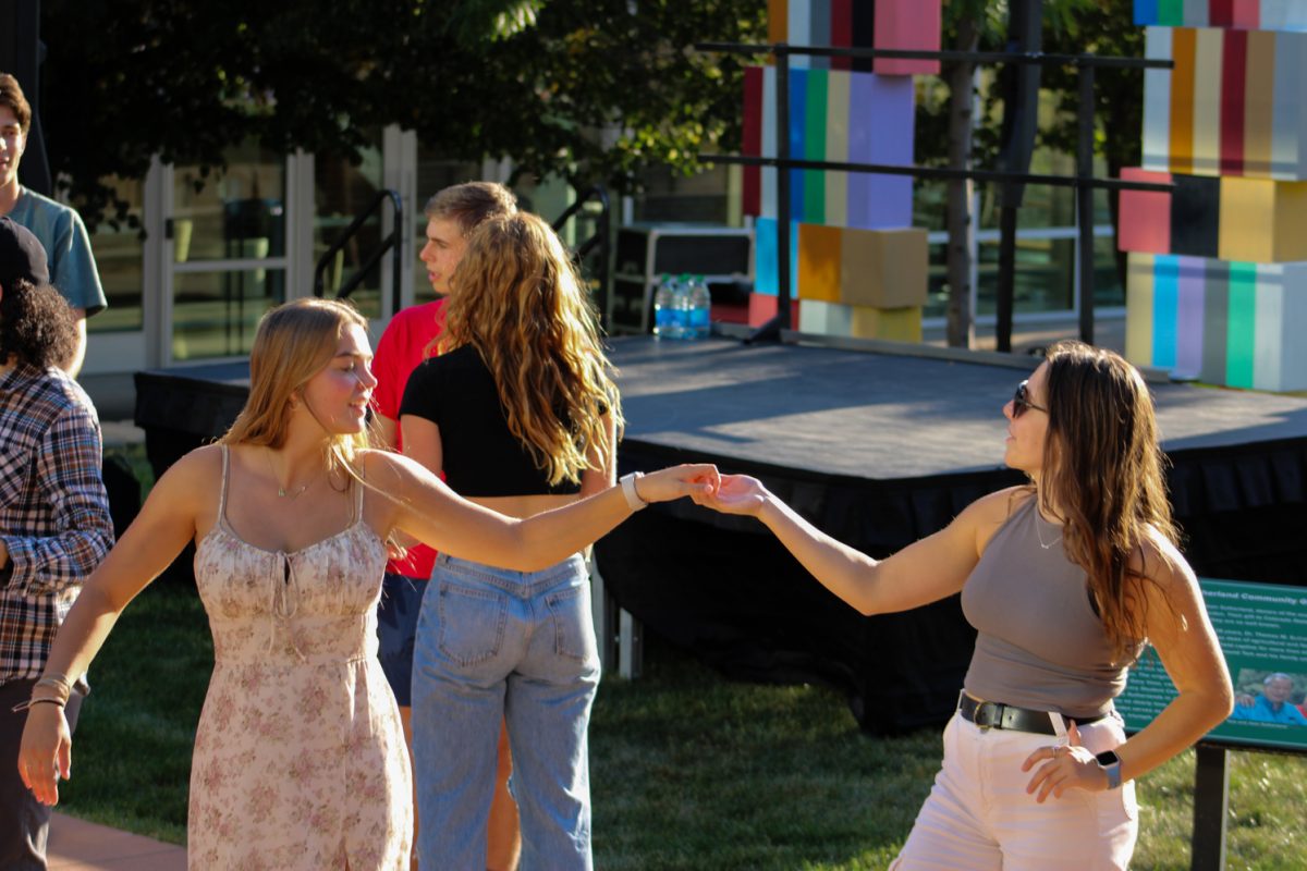 Colorado State University student couple swing each other around during the Bachata dance tutorial at the National Latinx Heritage Month launch at the Sutherland Garden Sept. 13. CSU undergrads got a chance to learn more about the Latinx culture through dance as well as El Centro in a judgment free zone. 