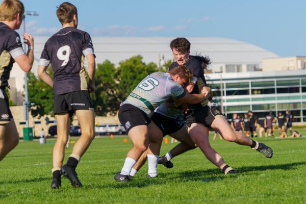 Thomas Leachman (16) of Coloradao State University Mens Rugby tackles a Colorado Boulder player during a match between CSU and CU Sept. 17
