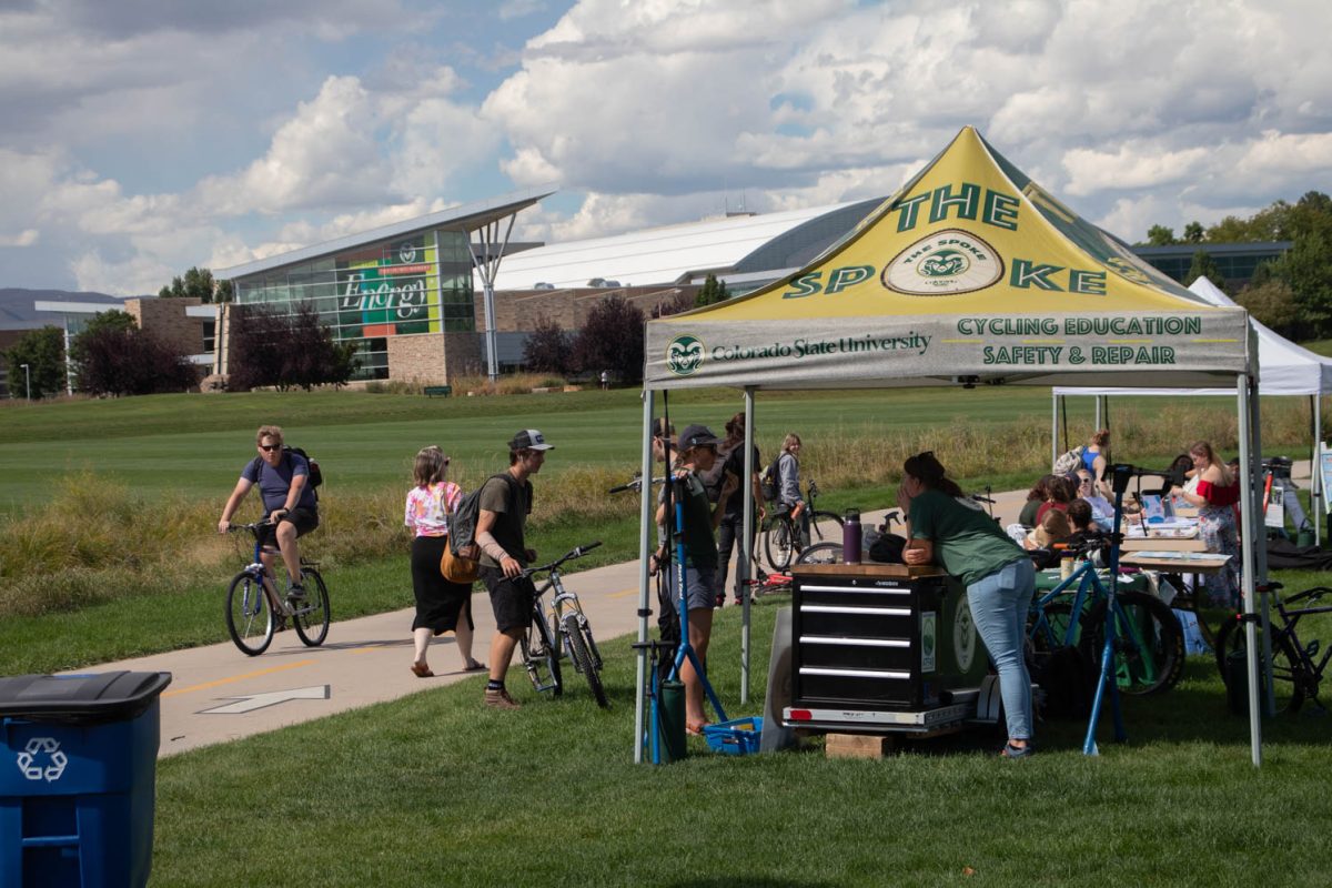 Students and community members chat with different tables during the Bike to School event at Colorado State University.